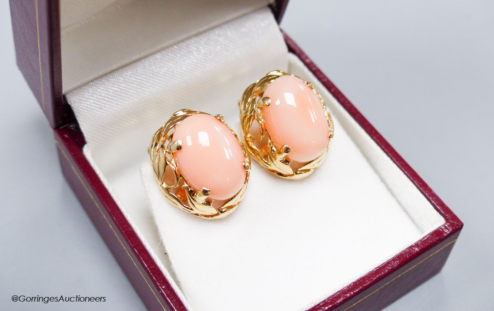 A modern pair of yellow metal (stamped 14k) and oval coral bead earrings, 16mm